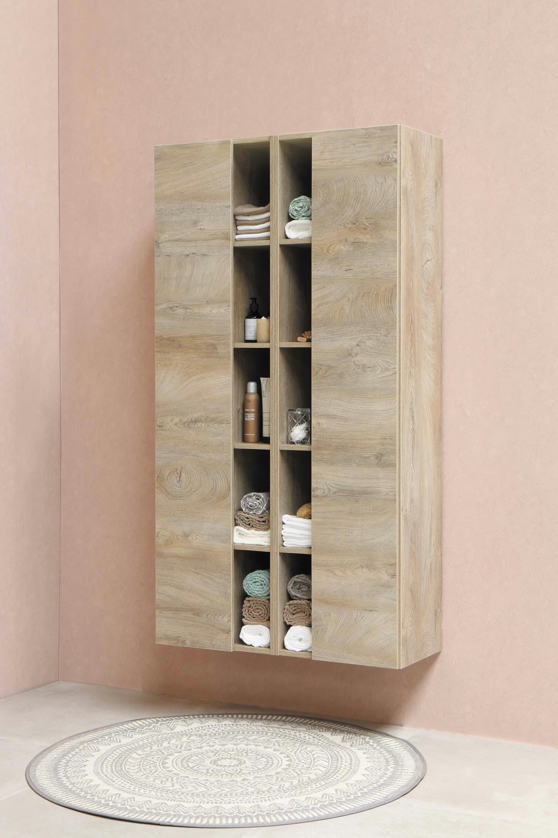 Tall timber wardrobe cabinet with open shelving against a blush wall